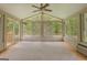 Bright sunroom with multiple windows offering serene views of surrounding greenery at 145 County Line Ct, Fayetteville, GA 30215