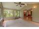Inviting sunroom with scenic views, vaulted ceiling, and access to the main house at 145 County Line Ct, Fayetteville, GA 30215