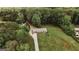 Stunning aerial view of a home with a long driveway and sprawling green lawn surrounded by mature trees at 8394 Banks Mill Rd, Douglasville, GA 30135