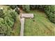 Aerial view of a charming home with a long driveway, surrounded by lush greenery and mature trees at 8394 Banks Mill Rd, Douglasville, GA 30135