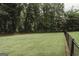 Spacious backyard with a black chain-link fence, offering a secure and private outdoor space at 8394 Banks Mill Rd, Douglasville, GA 30135