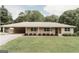 Inviting home with well-manicured lawn and classic architectural design with lovely landscaping at 8394 Banks Mill Rd, Douglasville, GA 30135