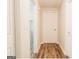 Clean and well-lit hallway with hardwood floors and white doors at 8394 Banks Mill Rd, Douglasville, GA 30135