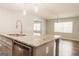 Close up on kitchen island with granite countertops and stainless steel dishwasher at 8394 Banks Mill Rd, Douglasville, GA 30135