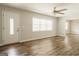 Open-concept living area with modern ceiling fan and hardwood floors at 8394 Banks Mill Rd, Douglasville, GA 30135