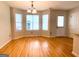 Dining area featuring hardwood floors, natural lighting, and a pendant chandelier at 1843 Grove Way, Hampton, GA 30228