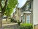 View of multiple brick townhomes with black shutters, sidewalks, and landscaping at 1843 Grove Way, Hampton, GA 30228