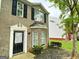 Charming brick townhome with black shutters and inviting front yard at 1843 Grove Way, Hampton, GA 30228