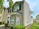 Charming brick townhome with black shutters and a well-maintained lawn at 1843 Grove Way, Hampton, GA 30228