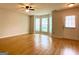 Inviting living room featuring hardwood floors, large windows, and a ceiling fan at 1843 Grove Way, Hampton, GA 30228