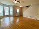 Spacious living room with hardwood floors, natural light, and staircase access at 1843 Grove Way, Hampton, GA 30228