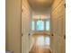 Hardwood floors flow from the foyer into the living room with bay window at 1843 Grove Way, Hampton, GA 30228
