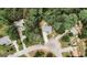 Overhead view of a home nestled among mature trees on a large lot, with a winding driveway and manicured landscaping at 228 Hunt Club Cir, Temple, GA 30179