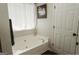 Bright bathroom featuring a large tub, providing a spa-like experience at 228 Hunt Club Cir, Temple, GA 30179