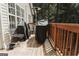 Covered deck with wood plank flooring, grill, patio heater, and an outdoor seating area at 228 Hunt Club Cir, Temple, GA 30179