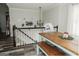 Dining area view with a wooden table, chairs, and a bench, with a staircase leading to the lower level at 228 Hunt Club Cir, Temple, GA 30179
