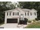 Charming two-story home featuring a well-maintained front yard and a welcoming entrance with an American flag at 228 Hunt Club Cir, Temple, GA 30179
