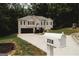 Charming home with a two-car garage, inviting entryway, and well-maintained front yard at 228 Hunt Club Cir, Temple, GA 30179