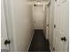 Neutral hallway with several white paneled doors and a flush mount ceiling light at 228 Hunt Club Cir, Temple, GA 30179