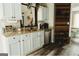 Open kitchen showcasing stainless steel appliances, light blue cabinets and a view of a dining area at 228 Hunt Club Cir, Temple, GA 30179