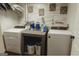 Bright laundry room featuring front loading machines, farmhouse decor, and a wood-look accent wall at 228 Hunt Club Cir, Temple, GA 30179