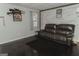 Cozy living room featuring wood paneling and comfortable leather seating at 228 Hunt Club Cir, Temple, GA 30179