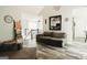 Bright living room featuring a comfortable sofa, modern decor, and an open view of the kitchen area at 228 Hunt Club Cir, Temple, GA 30179