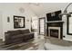 Spacious living room featuring a fireplace, a comfortable sofa, and an open doorway to the dining area at 228 Hunt Club Cir, Temple, GA 30179
