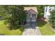 Aerial view showcasing a pink home with a long driveway, surrounded by lush greenery and mature trees at 300 Fox Trail Dr, South Fulton, GA 30349