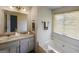Bathroom featuring double sinks, tub, window, and modern fixtures providing a functional space at 300 Fox Trail Dr, South Fulton, GA 30349