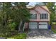 Charming two-story home with a two-car garage, framed by mature trees and a well-maintained lawn at 300 Fox Trail Dr, South Fulton, GA 30349
