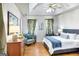 Serene bedroom features a tray ceiling, wood floors, and soft, natural lighting for relaxation at 300 Fox Trail Dr, South Fulton, GA 30349