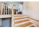 A staircase featuring painted white risers and wooden treads, leading to a bright upper level at 300 Fox Trail Dr, South Fulton, GA 30349