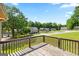 View from a wood deck overlooking neighborhood homes, mature trees and a clear blue sky at 300 Fox Trail Dr, South Fulton, GA 30349