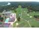 Aerial view featuring a community pool, tennis courts, and a golf course at 6026 Belle Meade Ct, Villa Rica, GA 30180