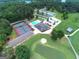 Aerial view showcases community amenities: pool, tennis courts, clubhouse, and putting green at 6026 Belle Meade Ct, Villa Rica, GA 30180