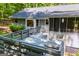 Aerial view of the raised outdoor deck with bench seating and stairs leading to the backyard area at 6026 Belle Meade Ct, Villa Rica, GA 30180