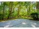 Green backyard area surrounded by mature trees at 6026 Belle Meade Ct, Villa Rica, GA 30180
