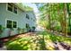 Spacious backyard with mature trees surrounding the home and a patio area perfect for outdoor gatherings at 6026 Belle Meade Ct, Villa Rica, GA 30180