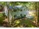 Aerial view of the spacious backyard, highlighting the home's exterior, patio, and wooded surroundings at 6026 Belle Meade Ct, Villa Rica, GA 30180