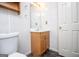 This bathroom includes a toilet, updated mirror, vanity, and vinyl flooring at 6026 Belle Meade Ct, Villa Rica, GA 30180