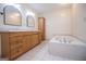 Bathroom showcasing a large bathtub, double vanity, and tiled floors at 6026 Belle Meade Ct, Villa Rica, GA 30180