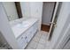 Bathroom with white vanity and sink featuring tile flooring and a doorway leading to another room at 6026 Belle Meade Ct, Villa Rica, GA 30180
