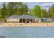 Community beach with picnic tables and lifeguard stand, providing a scenic waterfront experience at 6026 Belle Meade Ct, Villa Rica, GA 30180