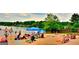Lakeside beach with families enjoying a day of fun in the sun near beautiful lakefront homes at 6026 Belle Meade Ct, Villa Rica, GA 30180