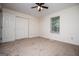 Comfortable carpeted bedroom features a ceiling fan and large closet at 6026 Belle Meade Ct, Villa Rica, GA 30180