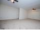 Spacious bedroom with neutral carpet, two ceiling fans, and a closet with sliding doors at 6026 Belle Meade Ct, Villa Rica, GA 30180