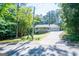 A front elevation shows the home's covered porch and a view of the surrounding trees at 6026 Belle Meade Ct, Villa Rica, GA 30180