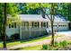 Charming single Gathering home with a manicured front lawn and a convenient two-car garage at 6026 Belle Meade Ct, Villa Rica, GA 30180