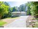 A front elevation shows the home's long driveway and a view of the surrounding trees at 6026 Belle Meade Ct, Villa Rica, GA 30180